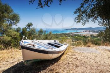 Old white fishing row boat on the coast. Summer landscape of Zakynthos island, Greece