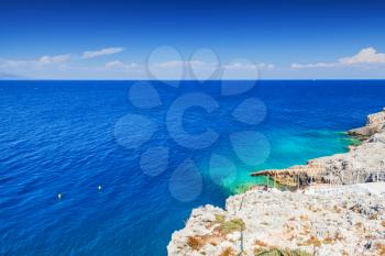 Landscape with gray coastal rocks of Greek island Zakynthos in the Ionian Sea, bright summer day