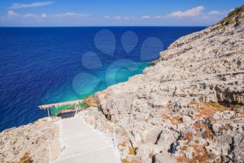 Coastal lane with chain fences. Greek island Zakynthos in sunny summer day