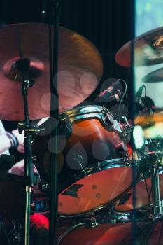Drum set on a stage with colorful illumination, life rock music photo background