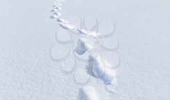 Human footprints in deep snowdrift, natural winter background photo