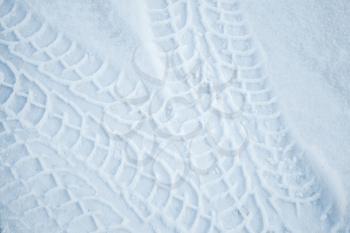 Tire tracks pattern on winter road with snow. Background texture