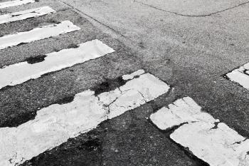 Pedestrian crossing road marking Zebra, white stripes over dark asphalt pavement, background photo texture