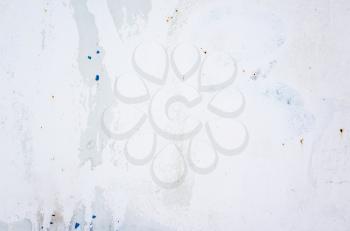 Old metal wall painted in white with cracks and spots, background texture