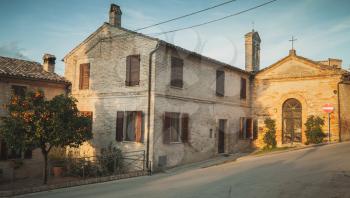 Street view of Fermo town with old living houses at evening, Italy. Vintage toned photo