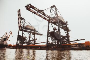Huge gantry cranes. Port of Burgas, Black Sea coast, Bulgaria. Vintage warm toned wide angle photo