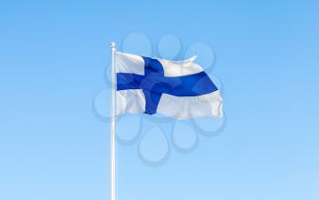 Flag of Finland, also called Blue Cross Flag over blue sky background