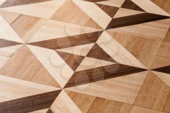 Classical wooden parquet design, geometric pattern with triangles and squares. Background photo texture