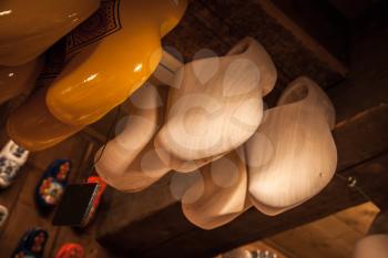 Clogs made of poplar wood hang in souvenir shop. Klompen is traditional Dutch shoes for everyday use