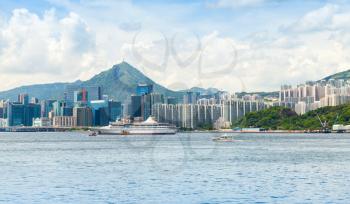 Landscape of Hong Kong city in summer day. Passenger ship moored near Yau Tong district of Hong-Kong island