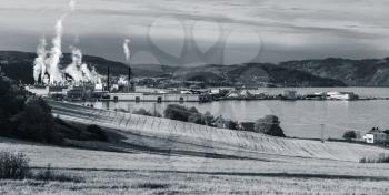 Norwegian monochrome panoramic landscape with pulp mill factory in Skogn, Norway