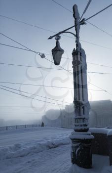 Cold winter in Saint Petersburg, Russia. Street lights on Mogilev bridge. Blue toned outdoor cityscape photo