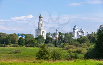 Rural Russian landscape with Orthodox Churches under blue cloudy sky in summer day. Veliky Novgorod, Russia