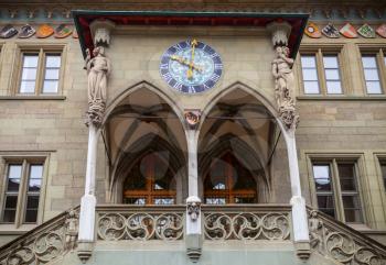 Bern Rathaus. Entrance to the town hall with coat of arms and ancient clock. Switzerland