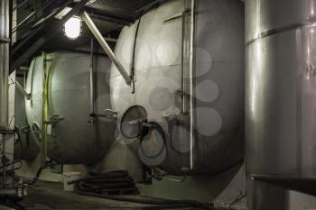 Steel tanks in a row, wine factory equipment