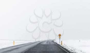 Frozen road covered with snow in windy winter day. Reykjavik district, Iceland