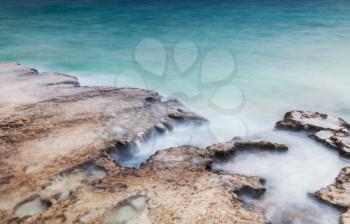 Mediterranean Sea rocky coast. Long exposure photo with natural effect of blurred water. Summer morning landscape of Ayia Napa, Cyprus island