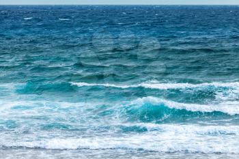 Blue water of Mediterranean Sea with shore waves, natural background photo taken from coast of Cyprus island