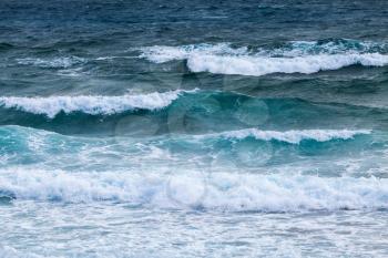 Blue water of Mediterranean Sea with shore waves, background photo taken from coast of Cyprus island