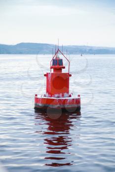 Red navigation buoy floating on sea water. Varna, Bulgaria