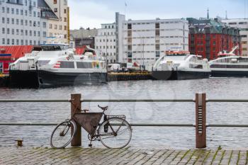 Old bicycle parked on the embankment in Bergen port, Norway