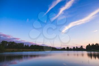 Dramatic landscape with still lake water under in evening cloudy sky, natural background photo