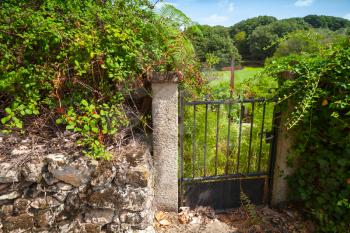 Old rusted garden gate with iron cross, Corsica, France