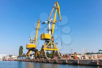 Port cranes work in Cargo port of Burgas city, Bulgaria. Seaside view
