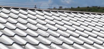 Light gray metal tile roofing, close-up background photo