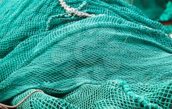 Pile of green fishing nets, background photo with selective focus and shallow DOF