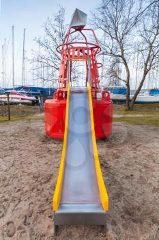 Slide made of old used navigation buoy on public playground. Muiderzand marina, Amsterdam, Netherlands