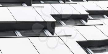 Abstract modern architecture background, shiny wall made of steel with dark windows