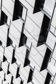 Abstract modern architecture vertical background, corners pattern, shiny walls of steel with dark windows