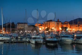 Pleasure yachts and motor boats moored in port of Ajaccio at night, Corsica island, France