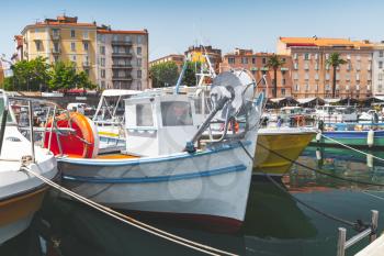 Vintage fishing boats moored in old port of Ajaccio, Corsica island, France. Retro stylized photo with tonal correction filter