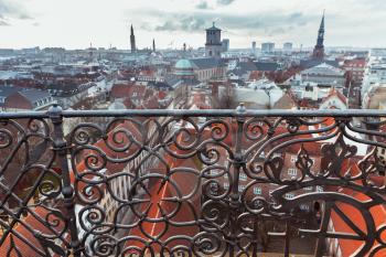 Skyline of Copenhagen, Denmark with decorative fence, photo taken from The Round Tower, popular old city landmark and viewpoint