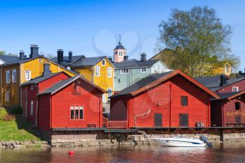 Porvoo town, Finland. Old red wooden houses on the river coast in sunny day