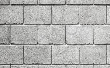 Stone wall made of gray foam concrete blocks, background photo texture, front view