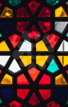 Stained glass window with geometric Arabic pattern, vertical photo