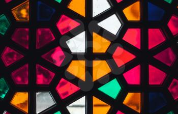 Stained glass window with geometric Arabic pattern, background texture