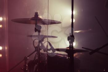 Live music background photo, rock band drum set. Vintage warm toned close up photo, soft selective focus