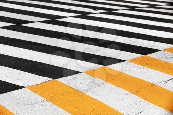 Pedestrian crossing road marking zebra on dark asphalt, background photo texture