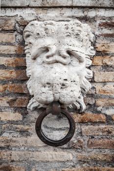 Stone lion head with ring on the facade of the Villa Medici, historic center of old Rome, Italy, Europe