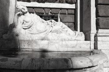 Street fountain with sleeping girl marble statue in Rome, Italy