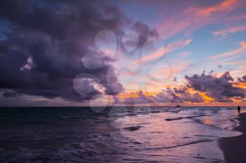 Coastal landscape with purple clouds at sunrise. Atlantic Ocean coast, Bavaro beach, Dominican Republic