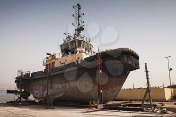 Old tugboat for repair at dock, Aqaba port, Jordan