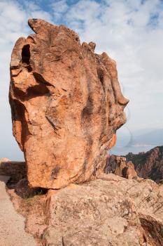 Huge stone stands on a roadside in Calanques de Piana. Corsica island, France