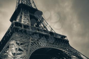Fragment of Eiffel Tower, the most popular landmark of Paris, France. Monochrome blue toned photo
