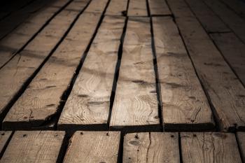 Dark old wooden floor. Background photo with perspective effect and selective focus