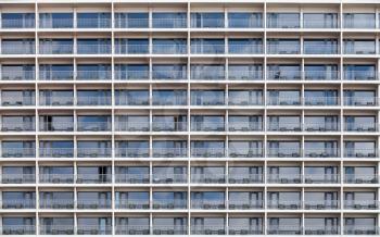 Modern building facade with windows and balconies, abstract architecture background photo
